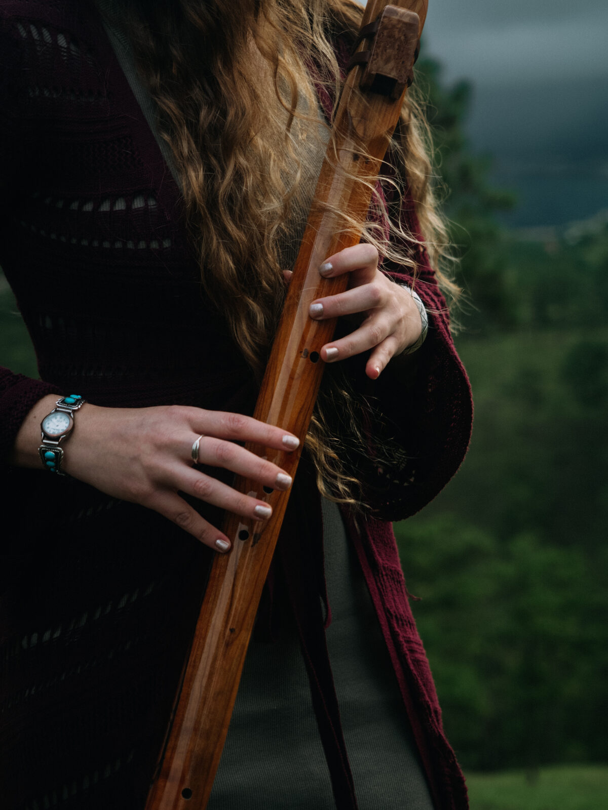 Close-up of hands holding a handcrafted Native American flute