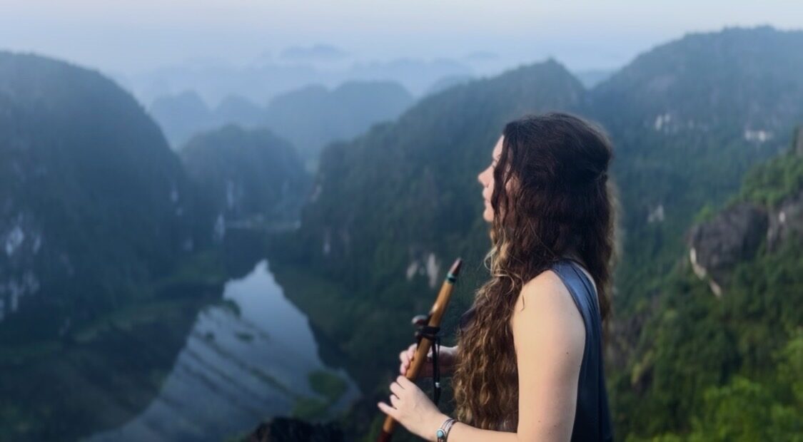 Performance overlooking karst mountains and a river